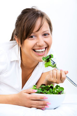 Young woman eating healthy salad