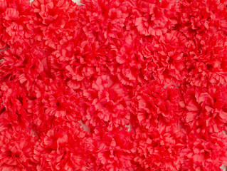 Red artificial flowers background