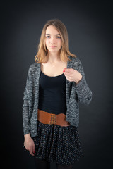 Beautiful woman doing different expressions in different sets of clothes: suspicion