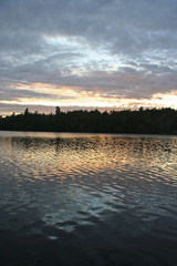 Clouds and Setting Sun Reflected in Rippled Lake