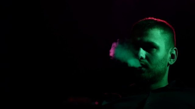 man  with hookah at shisha house. Slow motion. silhouette