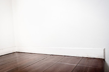Empty white wall and dark brown parquet floor in perspective vie