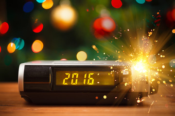 Led display of digital clock with 2016 new year with sparkler