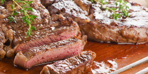 Beef steaks on   wooden board.