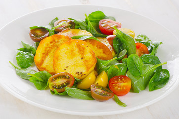 Roasted Cheese and tomato salad on a white plate.