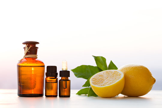 Lemon essential oils in bottles with lemon 