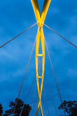 Superstructure of the tied arch bridge - yellow painted steel pipes of the Malt Footbridge (Kladka Slodowa) in Wroclaw, Poland.
