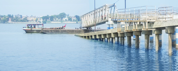 Fototapeta premium Jetty Ghat with a Boat carrying some person ..a panorama.
