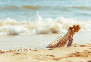 Bottle with SOS on the beach