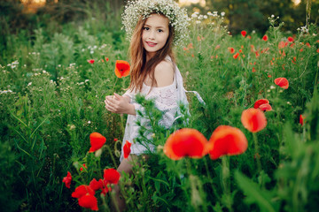 beautiful little girl posing   skirt in  wreath of poppies
