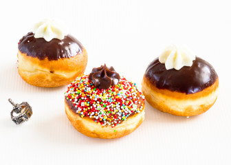 Sufganijots and silver dreidel   for  Hanukahh Holidays.