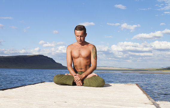 
young man meditating, yoga