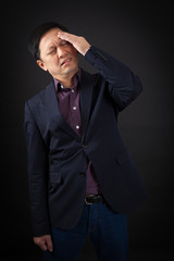 Fototapeta premium handsome man doing different expressions in different sets of clothes: headache