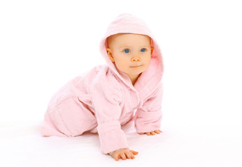 Portrait of cute little baby crawls in the pink bathrobe