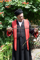 Serious Kuban Cossack checks blade of saber