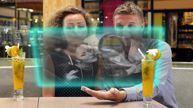 Modern Couple Use Futuristic Hologramic Media Player and