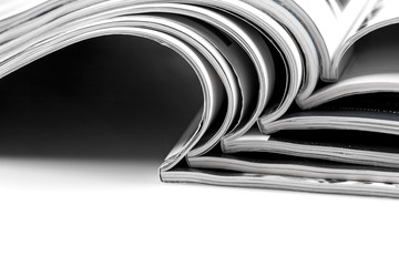 Stack of magazines on white background