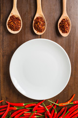 empty dish, red Chili peppers on wooden background