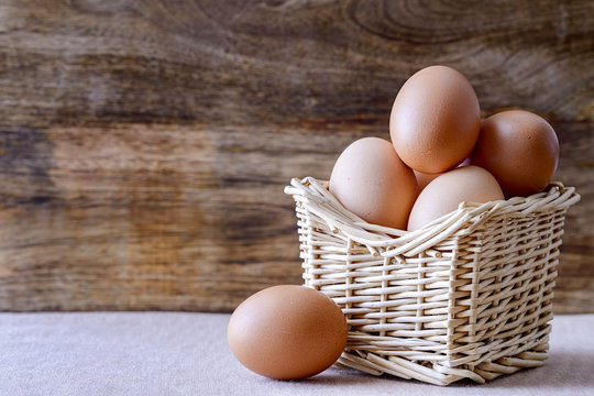 eggs in basket over wood