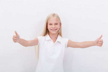 Portrait of a beautiful girl showing thumbs up on white