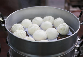 Steamed Chinese buns in silver steamer