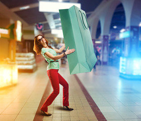 Woman holding huge shopping bag