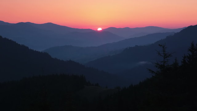 Sunrise over the Forested Mountains and Sunrays. Time Lapse