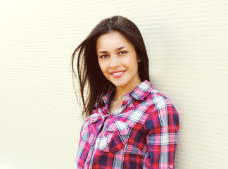 Fototapeta premium Portrait of pretty young woman in casual checkered shirt