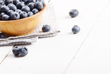 Wooden bowl with organic blueberries