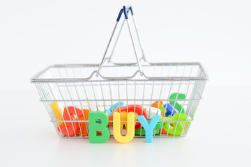 Buy or purchase concept with magnetic letters on a shopping basket