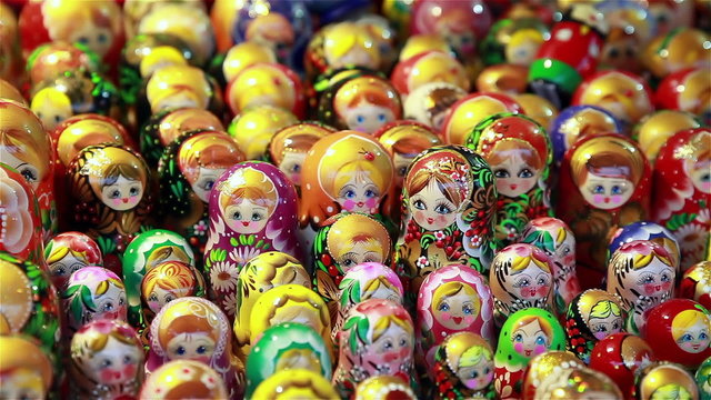 Many Russian wooden souvenirs (matrioshka, nesting dolls) on the counter.