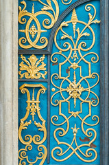 Blue door decorated with golden adornment