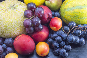 Various fruit on the dark wooden table
