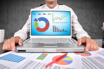 laptop with stock chart on screen