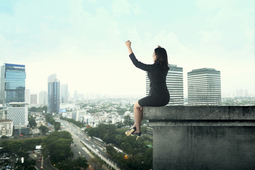 Fototapeta na wymiar Business Woman Sitting On Rooftop