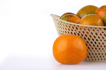orange fruit in basket, isolated on white background
