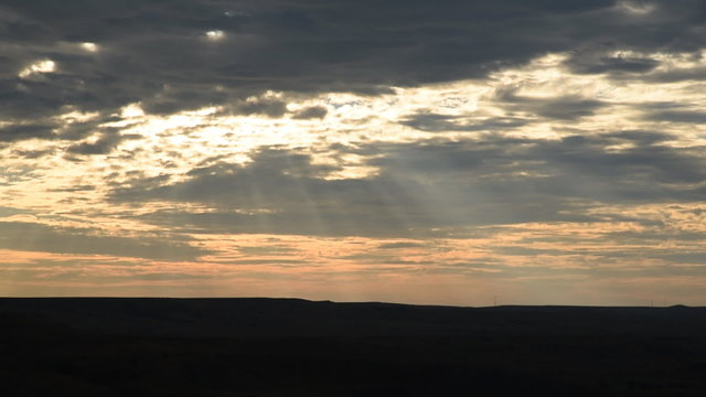 Two views of Sunset over the rolling hills of the Great Plains at Badlands National Park, South Dakota.