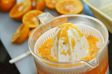 juicer machine with hand, fresh orange juice