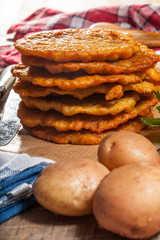 Potato pancake on a wooden table.
