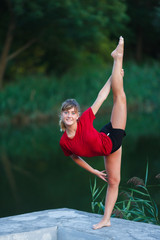 Cute young girl doing yoga exercises