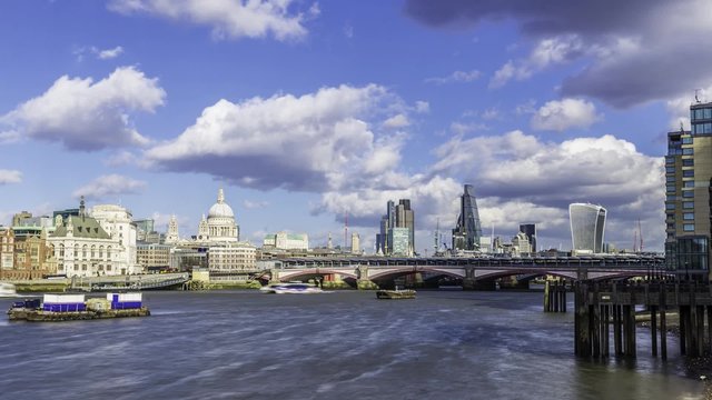 Timelapse view of St Paul cathedral and Blackfriars bridge with boats cruising on the river Thames  and the skyline of the City of London in the background