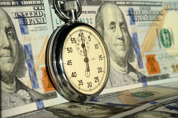 The timer on the background of dollar bills (advantages and disa