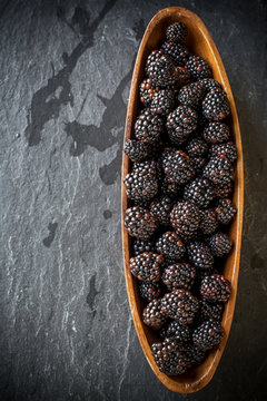Fresh blackberries in wooden bowl