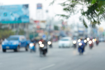 car and motorcycle driving on road with traffic jam in the city, abstract blurred