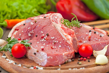 Raw beef steak with spice and vegetables