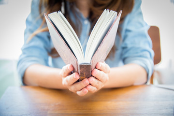 close up woman hand holding pocket book to read.