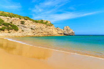 Fototapeta na wymiar Golden sand Barranco beach on western coast of Portugal