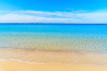 Fototapeta na wymiar Sea wave with crystal clear azure water on beautiful sandy beach Grande Sperone, Corsica island, France