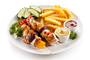 Grilled meat, French fries and vegetables 