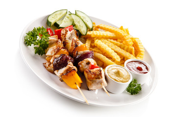 Grilled meat, French fries and vegetables 